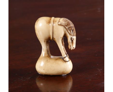 A JAPANESE IVORY NETSUKE OF A GRAZING HORSE, 19th Century, signed. 5cm