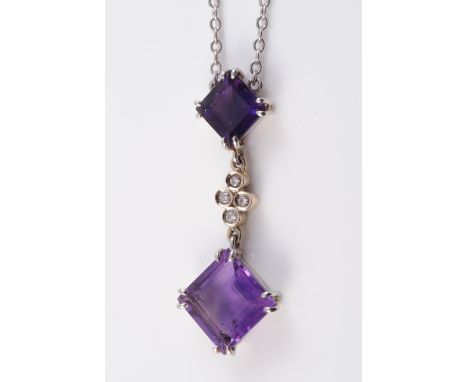 AN AMETHYST SET PENDANT, the two graduating square cut amethysts each claw set on articulated links with a subtle mount of fo