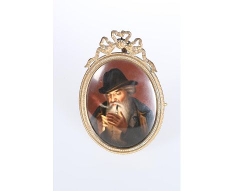 A CONTINENTAL PAINTED PORCELAIN MINIATURE, depicting a bearded man lighting a pipe, the gilt-metal frame with ribbon tied cre