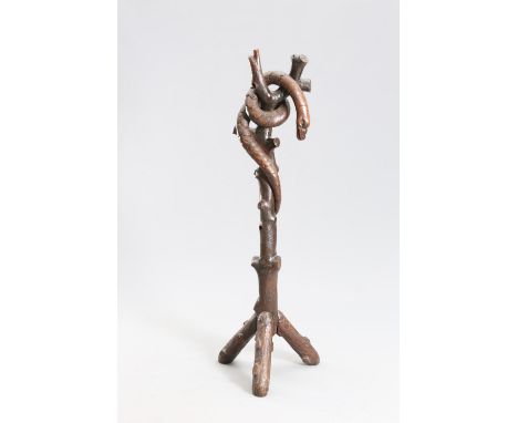 A CARVED OAK "SERPENT" HAT AND COAT STAND, the sinuous creature carved wrapped around a stem carved as a tree trunk, raised o