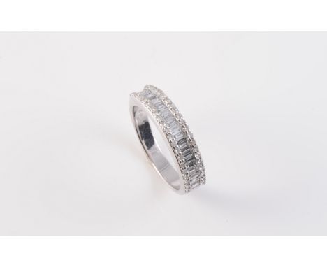 AN 18CT WHITE GOLD AND DIAMOND RING, the channel set baguette cut diamond highlights set centrally between two outer rows of 