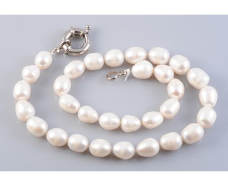 A CULTURED PEARL NECKLACE, the thirty one oval cultured pearls each strung knotted onto a heavy bolt ring clasp. Total length