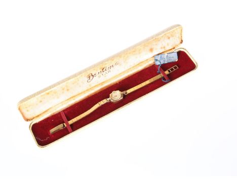 A VINTAGE LADY'S 9ct GOLD WRISTWATCH, the white enamel dial with baton numerals signed Bentima Star, in a cushion shaped case