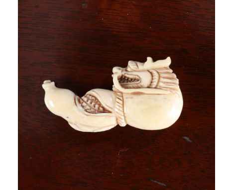 A JAPANESE IVORY NETSUKE, Meiji period, carved as a dragon emerging from a gourd. 5.5cm