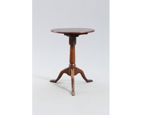 A GEORGE III OAK AND PINE TRIPOD TABLE, the circular pine top raised on a tapering oak stem continuing to downswept legs term