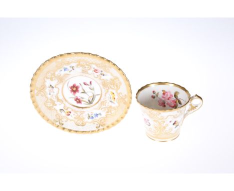 A CHAMBERLAINS WORCESTER CUP AND SAUCER, painted with floral sprigs and richly gilded, red printed factory mark.