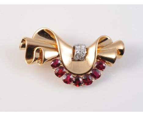 A RUBY AND DIAMOND SET BROOCH IN THE MANNER OF VAN CLEEF AND ARPELS, intricately folded and coiled metal detailing set with a