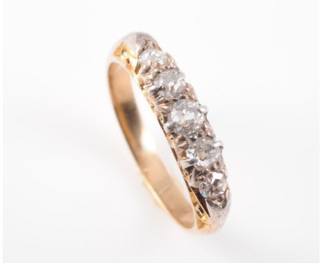 A DIAMOND SET RING, the five graduating old brilliant cut diamonds each set in a subtle scroll detail mount between solid tap
