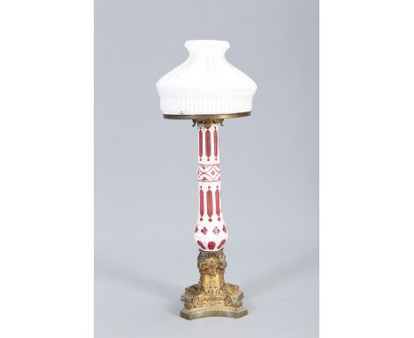 A LARGE 19TH CENTURY PALMER &amp; CO PATENT GILT-METAL, CRANBERRY AND OPALINE GLASS TABLE LAMP, the shade raised on a brass c