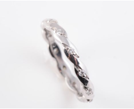 AN 18CT WHITE GOLD AND DIAMOND ETERNITY RING, the twist style mount set evenly spaced to the entirety with brilliant cut diam