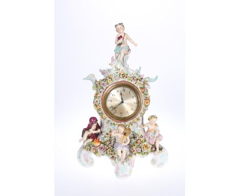 A DRESDEN PORCELAIN MANTEL CLOCK, LATE 19th CENTURY, the brass rimmed dial with Arabic numerals within a floral-encrusted cas
