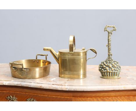 A GROUP OF LATE 19th/EARLY 20th CENTURY BRASS comprising: a door porter cast as a basket of fruit; a watering can; and a twin