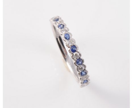 AN 18CT WHITE GOLD, SAPPHIRE AND DIAMOND RING, the nine round cut sapphire highlights alternately spaced with eight brilliant