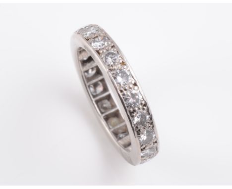 A DIAMOND ETERNITY RING, the twenty brilliant cut diamonds set to the entirety. Ring size Q. Weight 4.7gms