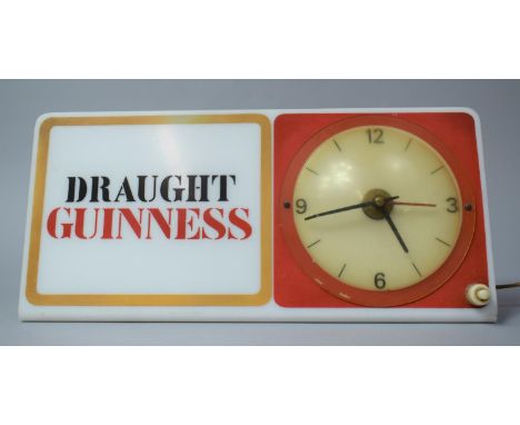 A Vintage Illuminated Shelf Mount Adverting Clock for Draught Guinness 