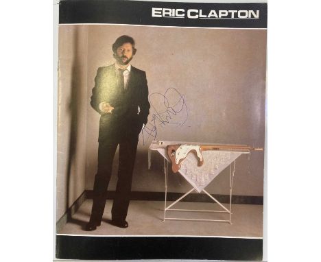 A 1983 Eric Clapton concert programme with two ticket stubs, signed to front of the cover in blue ink by Eric Clapton. Signat