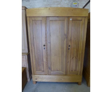 A Continental three door wardrobe circa 1930 -  fully sectional with hanging and shelf compartment, stripped and waxed - Heig