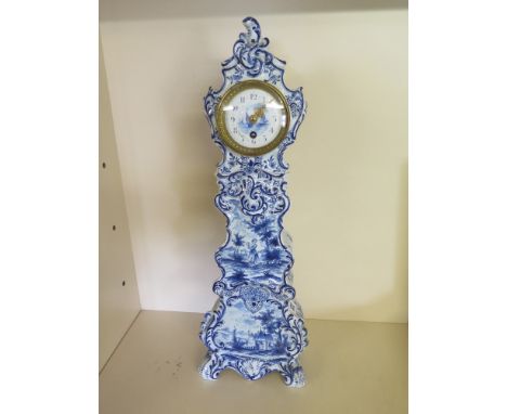 A tall Delft blue and white clock in the shape of a Continental longcase clock - Height 56 cm
Condition report: Some chips to