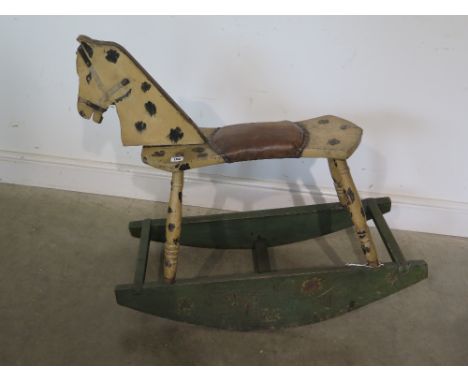 A primitive style painted rocking horse 84cm tall x 92cm long