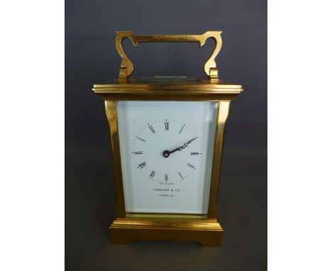 A good late 20th century brass glass carriage clock Garrard & Co London with a white enamel face -Height 13.5 cm 
Condition r