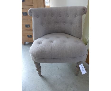A new upholstered button back bedroom chair