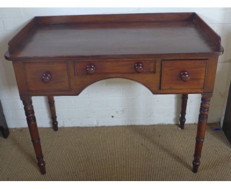 A 19th century mahogany writing table with three drawers, galleried back and ring turned tapering legs - Width 98 cm