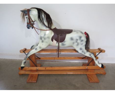 A good quality Haddon Rockers hand made wooden rocking horse with leather tack 1.3m tall x 1.8m long