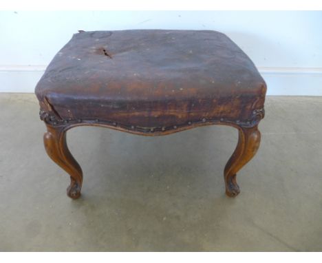 A 19th century walnut stool on carved cabriole legs 
Condition report: With a worn leather top