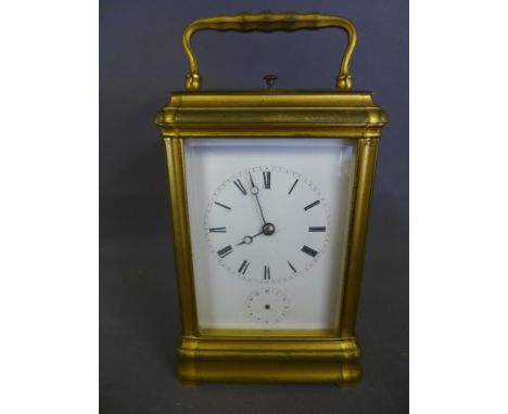 A 19th century French gilt metal cased petite/grande sonnerie striking carriage clock. The rectangular case with swing handle