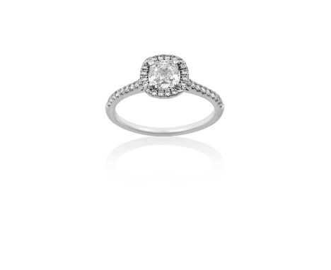 A Platinum Diamond Cluster Ringthe cushion shaped diamond within a border of round brilliant cut diamonds, to round brilliant