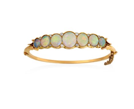 An Opal and Diamond Banglethe seven graduated oval cabochon opals spaced by old cut diamond accents, in yellow rubbed over se