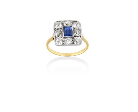 A Sapphire and Diamond Cluster Ring the rectangular step cut sapphire in a white millegrain setting, within a border of old c