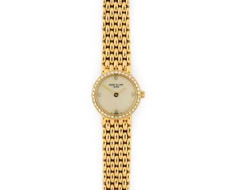 Patek Philippe: A Lady's 18 Carat Gold Diamond Set Wristwatch, signed Patek Philippe, Geneve, ref: 4707/11, 1986, (calibre E1