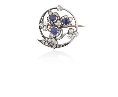 An Early 20th Century Sapphire and Diamond Broochthe central floral cluster comprising of a raised old cut diamond in a white