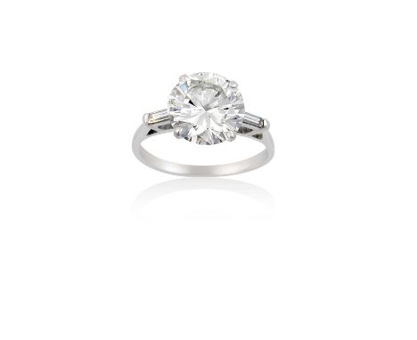 A Platinum Diamond Solitaire Ringthe round brilliant cut diamond in a four claw setting, to baguette cut diamond set shoulder