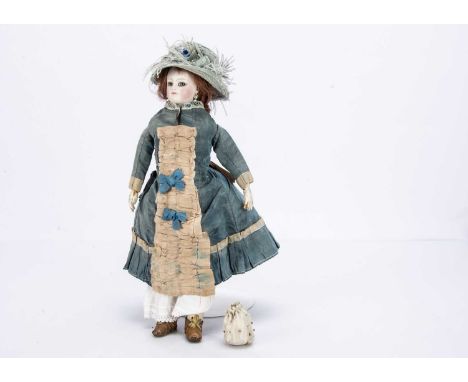 A small French pressed bisque swivel head fashionable doll, with grey glass eyes with darker edge to iris, light brown feathe