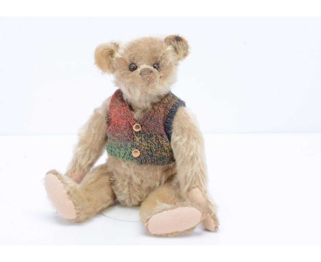 An early  Steiff teddy bear, circa 1912,  with honey gold mohair, black boot button eyes, pronounced muzzle, black stitched n
