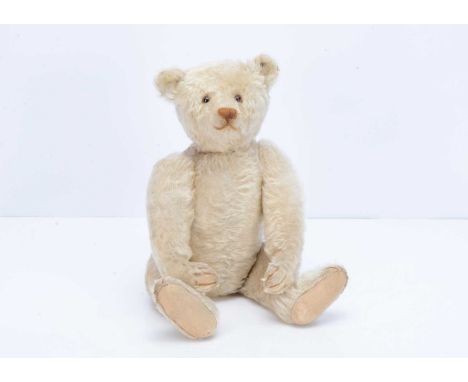 A fine Steiff white mohair  teddy bear, circa 1920, with clear and black glass eyes with brown painted backs, pronounced clip