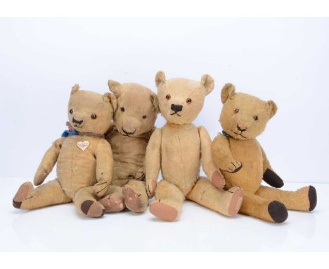 Four Chad Valley teddy bears, Wellington-Heath, with golden mohair, orange and black glass eyes, black stitched nose, mouth a