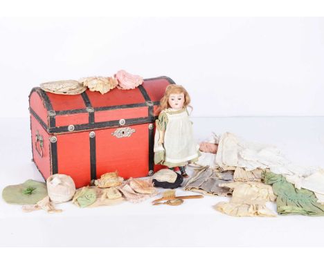 A small Kammer & Reinhardt child doll with trunk and trousseau, with brown sleeping eyes, blonde mohair wig, composition stra