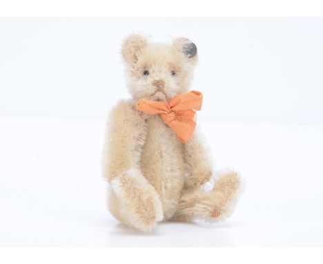 A 1926 -1934 Steiff miniature teddy bear,  with white mohair, black glass eyes, brown stitched nose and mouth, swivel head,  
