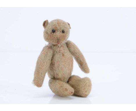 A larger WW1 'soldier' teddy bear, with blonde mohair, black glass eyes, red stitched nose and mouth, felt ears, swivel head 