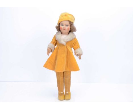 A 1930s Chad Valley long legged girl doll,  with pressed brushed cotton head, inset blue and white glass eyes, brown hair wig