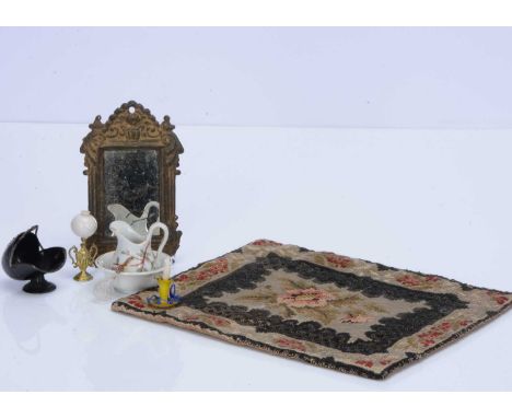 Earlier dolls’ house chattels,  an embossed tinplate wall mirror painted gold —4 ½in. (11.5cm.) high, an embroidered carpet; 