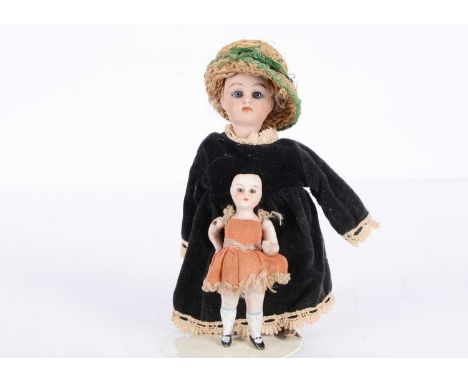 A small Kammer & Reinhardt child doll,  with fixed blue glass eyes, closed mouth, remains of blonde mohair wig, composition b