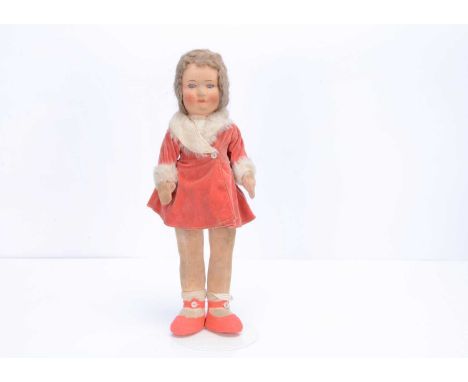 A 1930s Chad Valley long legged girl doll,  with pressed brushed cotton head, inset blue and white glass eyes, brown hair wig