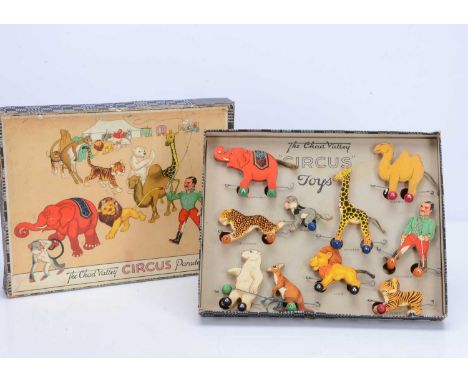 A Chad Valley Circus Parade, in original box,  printed paper laid onto wood cut-out animals and trainer with circular wooden 