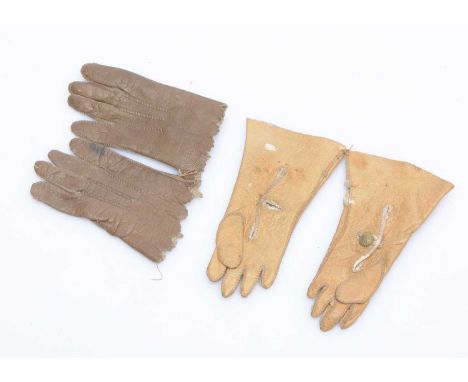 Two pairs of fashion doll’s gloves,  one pair of light tan —2 ½in. (6.5cm.) long and another pair in brown (both sets missing