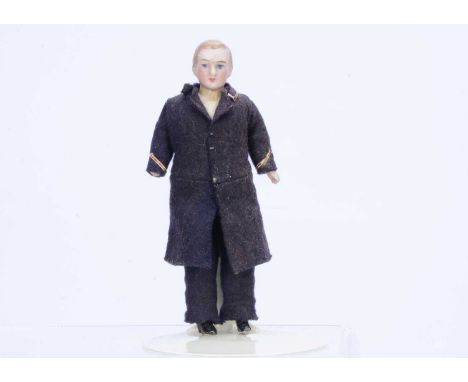 A German bisque shoulder head male dolls’ house doll,  with blue painted eyes, light brown painted side parted hair, stuffed 