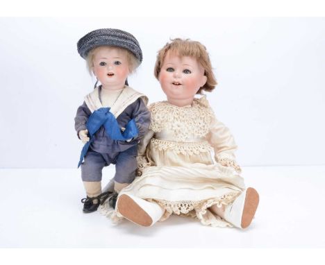 A Goebel B1 toddler doll,   with grey lashed sleeping eyes, light brown hair wig, composition body and cream cotton and lace 